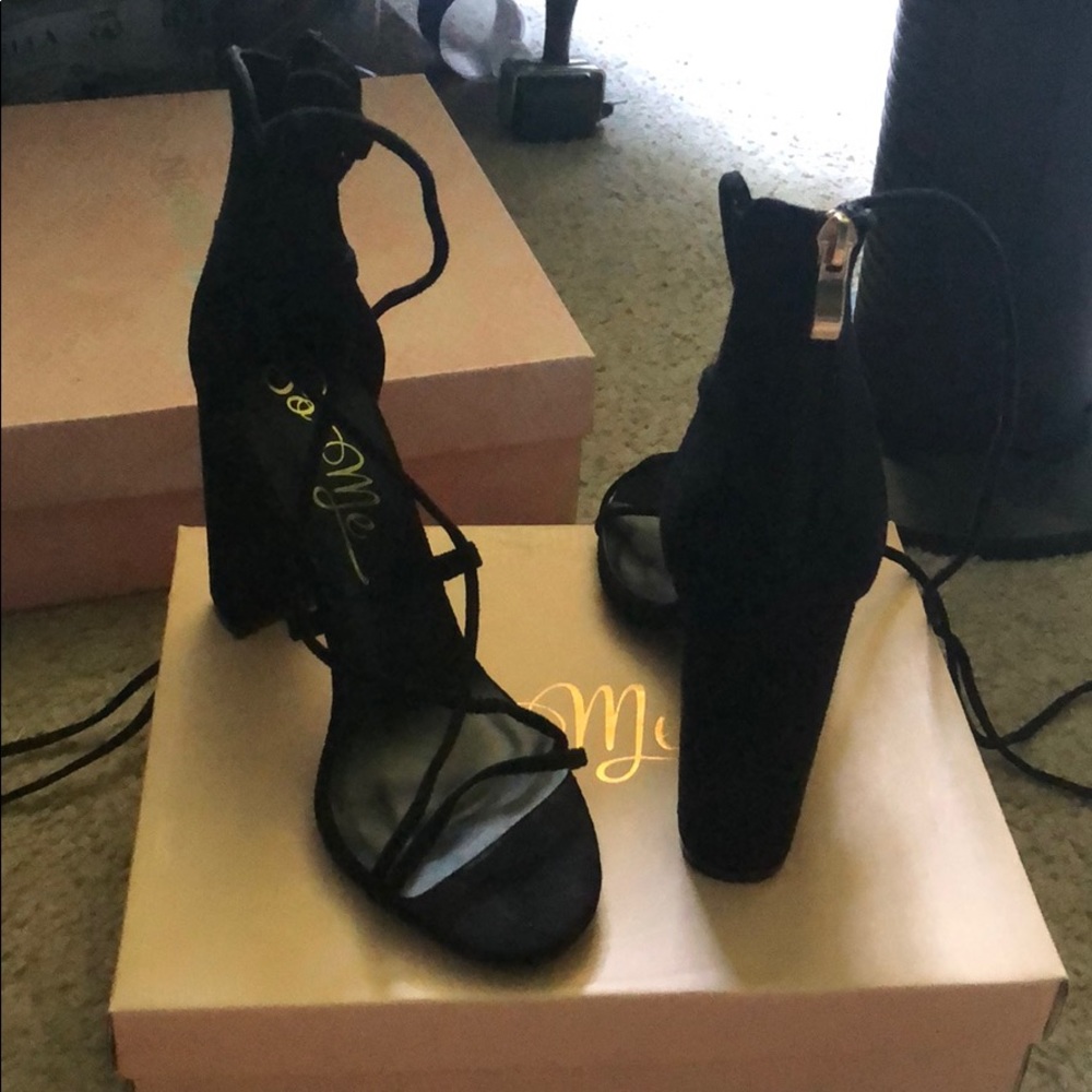 Black heels that tie up part of the calf
